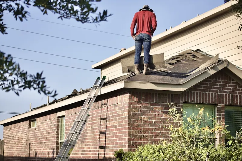 Professional roofer working on a residential roof in Churchill Downs